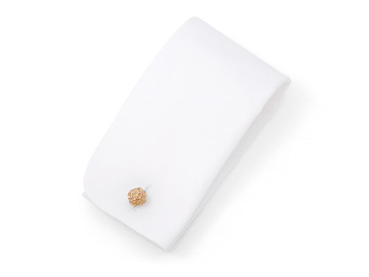 Textured 14K gold cufflink on white display pad