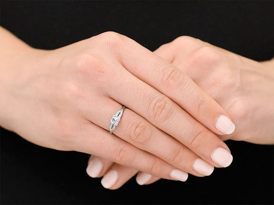 Platinum diamond ring worn on folded hands