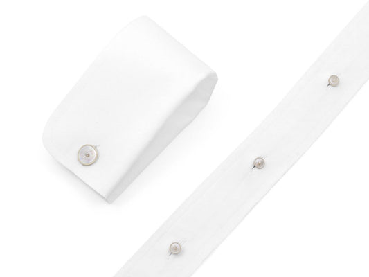 White shirt cuffs and studs with mother of pearl