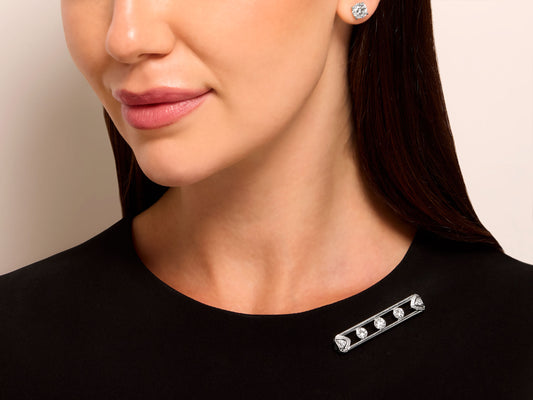 Woman wearing a diamond bar brooch on a black top