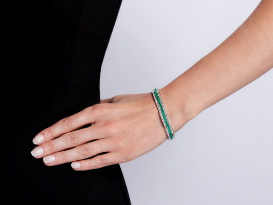 Three row emerald and diamond bracelet on wrist