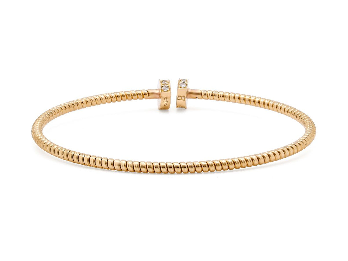Slim 18K yellow gold tubogas bracelet with diamond nail head terminals