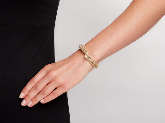 Double row 18K gold wrap bracelet worn on wrist