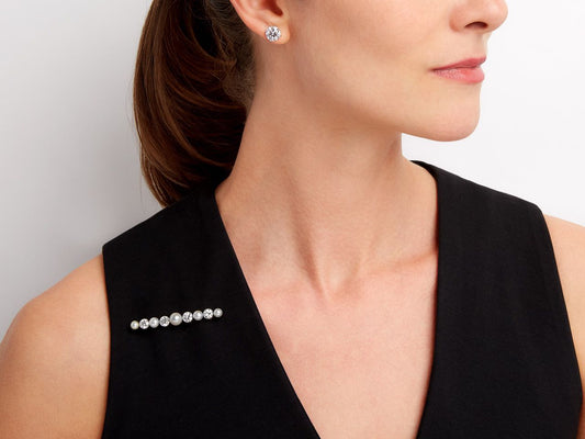 Graduated pearl and diamond brooch on black top