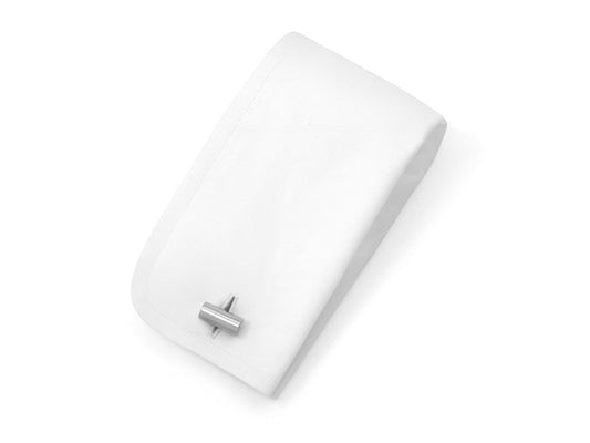 Single 18K white gold bar cufflink on a display cushion