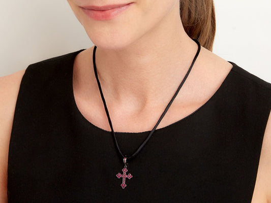 Ruby cross pendant on black silk cord