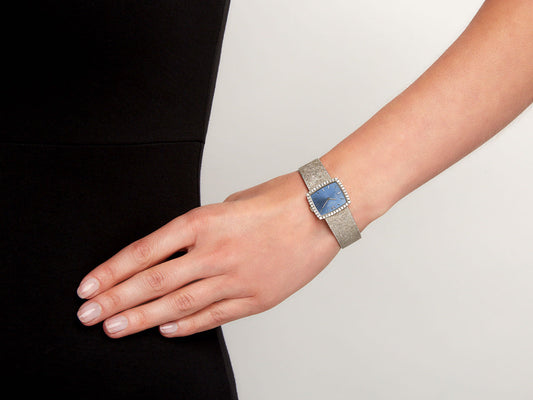 Blue dial diamond bezel watch on wrist