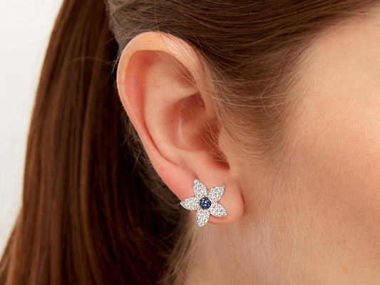 Flower earring with blue sapphire center and diamond petals
