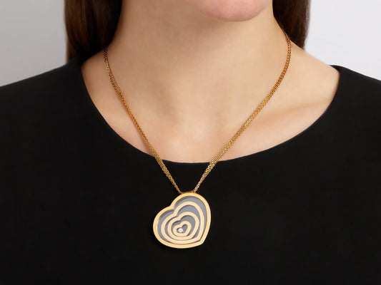 Gold heart necklace with concentric hearts and central diamond