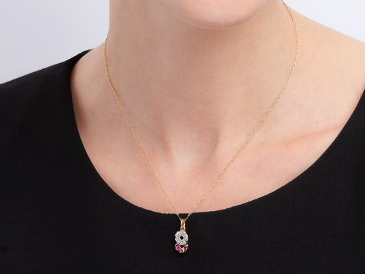 Ruby and diamond gold pendant necklace worn on model