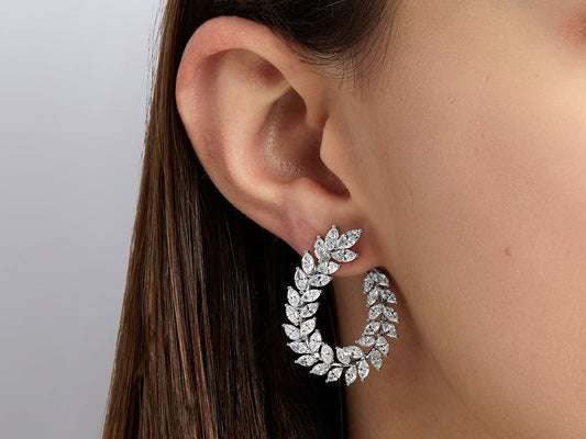 Diamond wreath earring in 18K white gold on an ear