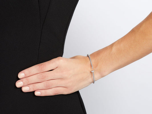 Slim 18K white gold nail bracelet worn on wrist