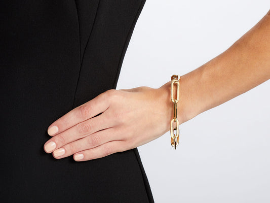 Polished 18K gold elongated link bracelet on wrist