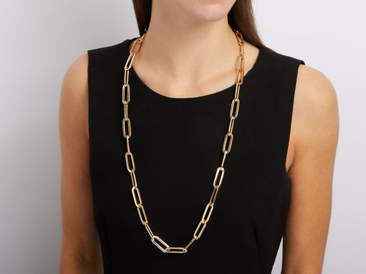 Model wearing a long polished 18K gold link necklace