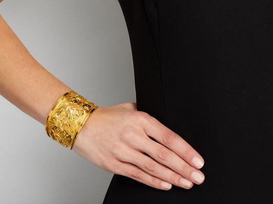 Textured 22K gold cuff bracelet on a wrist