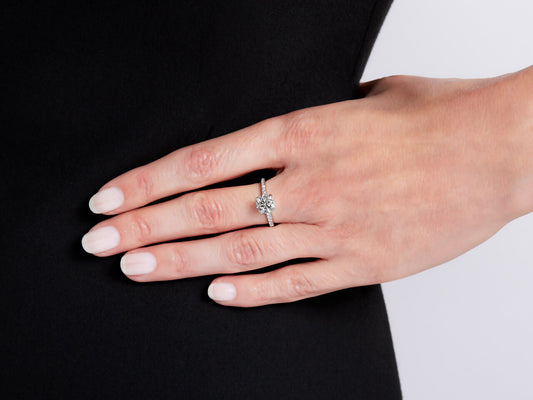Hand wearing a platinum diamond solitaire ring