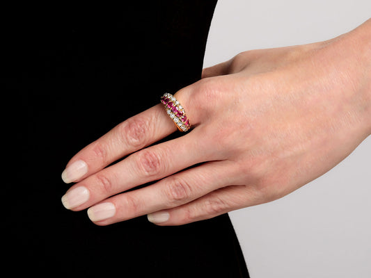Hand wearing an 18K gold ruby and diamond ring