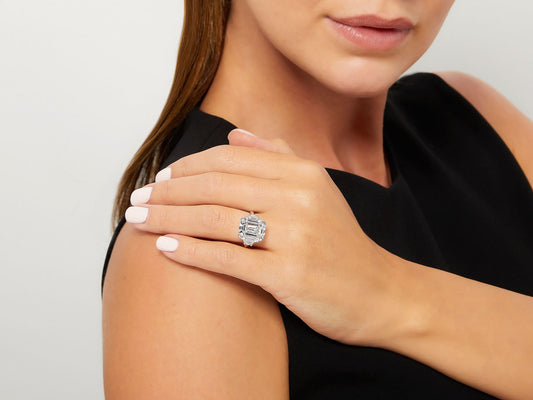 Emerald cut diamond ring with side stones on hand