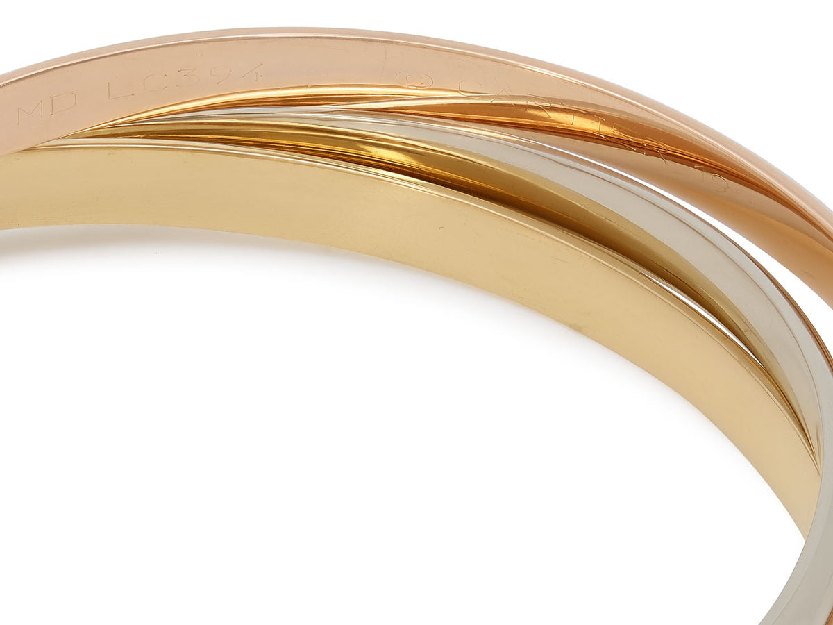 Close up of Cartier Trinity bangle in tri color 18k gold