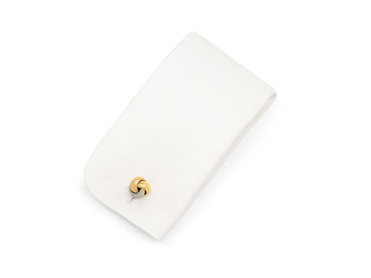 Cartier Trinity cufflink on white display cushion