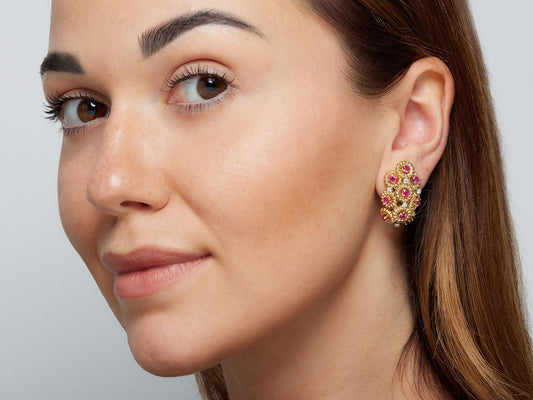 Close-up of a woman wearing a ruby and diamond earring
