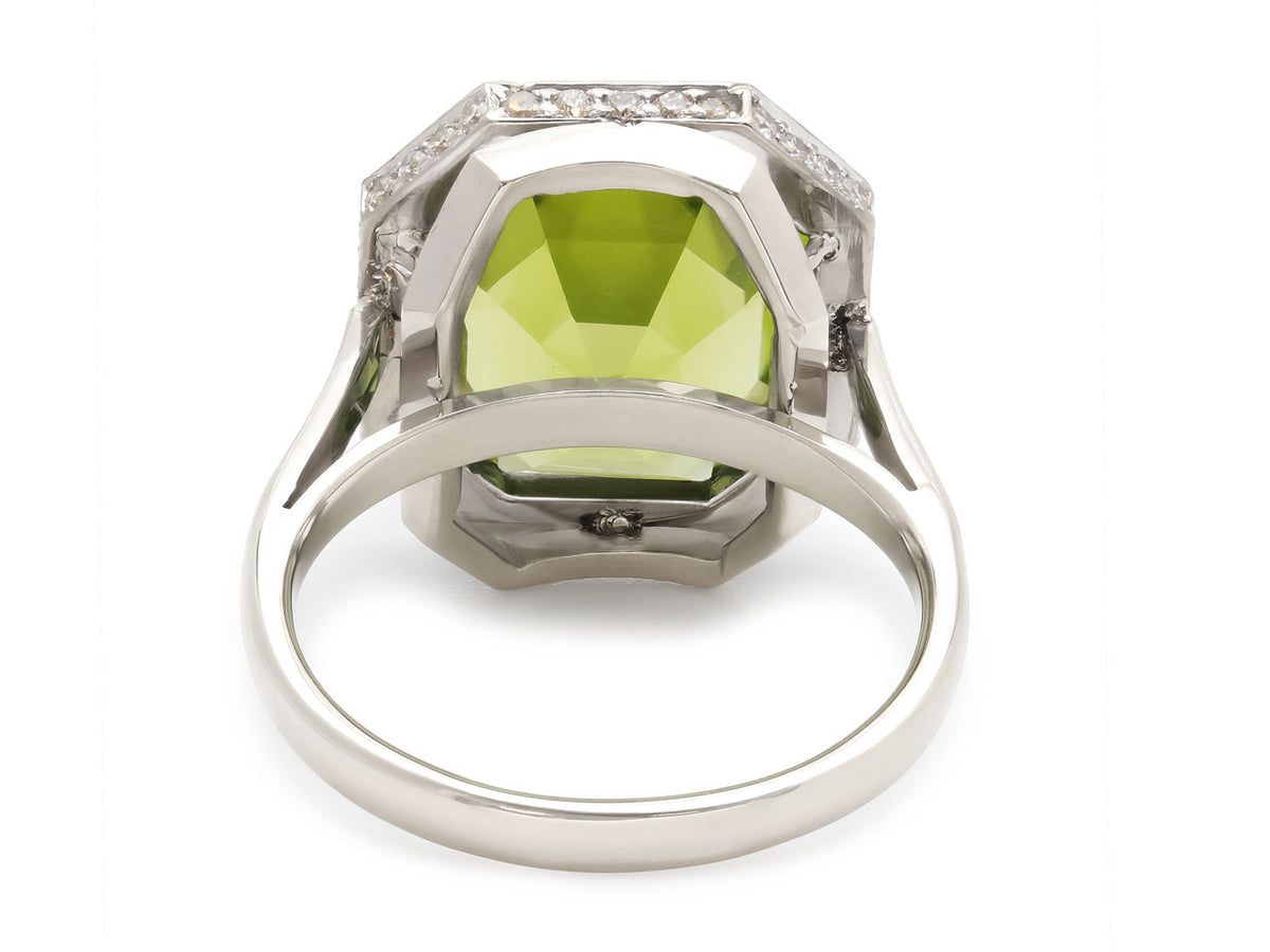 Rear view of white gold ring with green peridot and diamonds
