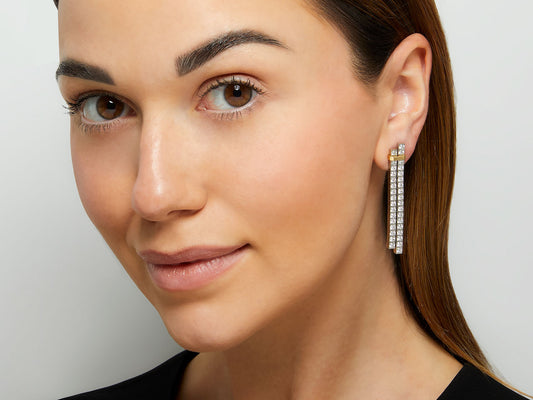 Model wearing a platinum and gold diamond drop earring