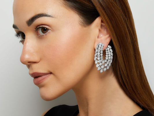 Model wearing an elongated platinum diamond earring