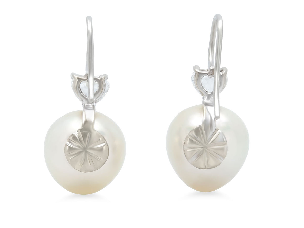 Pair of pearl earrings with white gold hooks and sunburst backs
