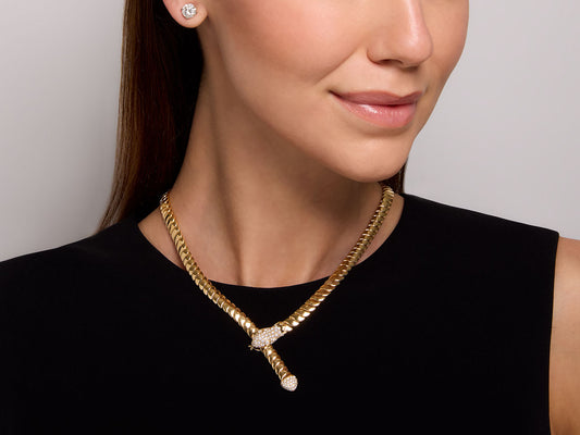 Woman wearing an 18K gold diamond snake necklace