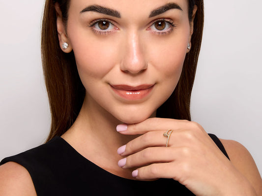 Woman wearing a pavé diamond nail ring in yellow gold