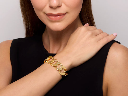 Gold curb link bracelet with white gold clasp on wrist