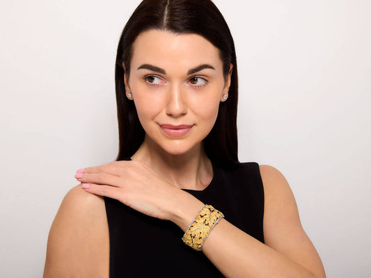 Woman wearing a gold and silver leaf cuff bracelet