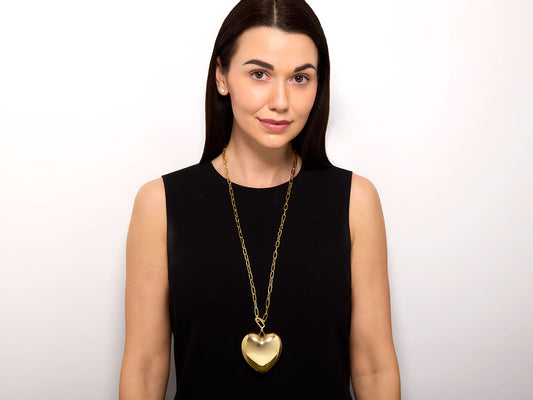 Model wearing a 14K gold puffed heart necklace