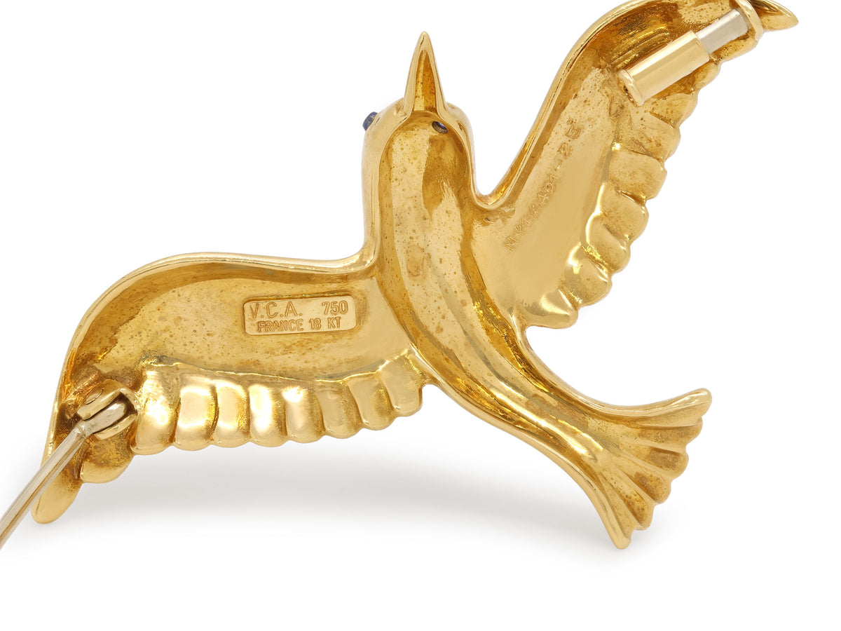 18K gold bird brooch in flight with sapphire eye