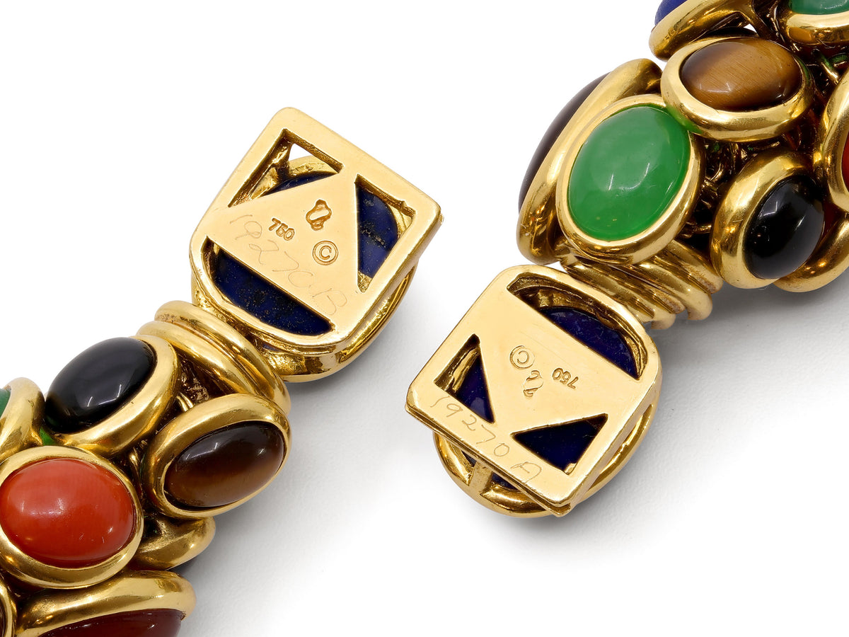 Close view of two 18K gold gemstone bracelet clasps
