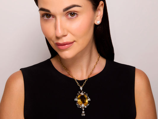 Antique Victorian Citrine and Diamond Pendant in Silver over Gold by Beladora, shown worn on a model with a large oval citrine and diamond drop