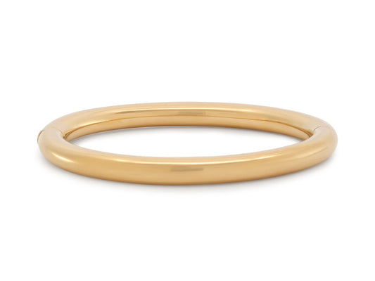 Bangle Bracelet in 18K Gold by Beladora rounded high polish yellow gold hinged bangle bracelet on a white background