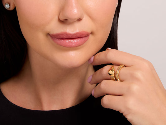 Viper Snake Ring in 18K Gold, by Beladora, flexible coiled bypass design in yellow gold worn on a woman's hand