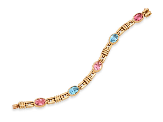 Bulgari Kunzite and Blue Topaz Bracelet in 18K Gold with bezel set pink kunzite, blue topaz, and alternating open and fluted gold links from Beladora