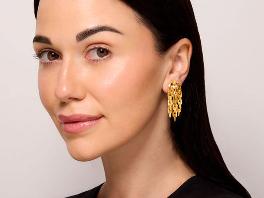 Beladora Leaf Earrings in 18K Gold worn on a model, featuring elongated hammered and fluted navette links in a cascading botanical design