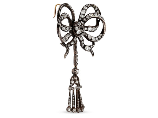 Antique Victorian Diamond Bow Pendant in Silver by Beladora, featuring old mine cut diamonds and a dangling diamond tassel with gold accents
