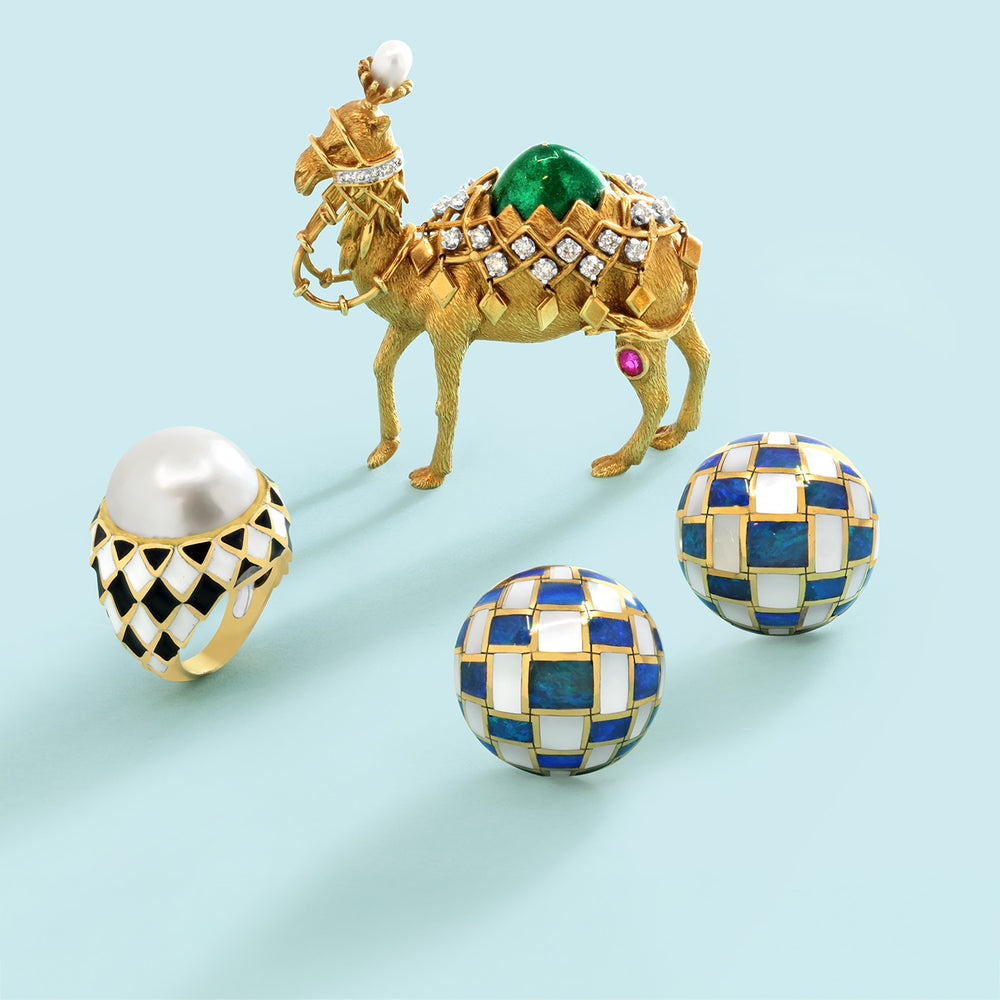 Gold Tiffany camel brooch, pearl Tiffany ring, and blue, white, and gold stud earrings