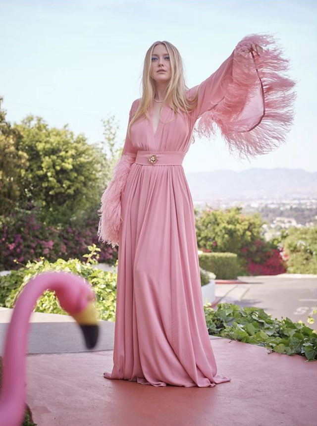 Woman in pink gown with feathered sleeves and flamingo