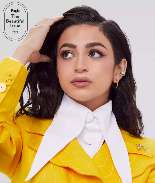 Portrait of a woman in a yellow outfit with white collar