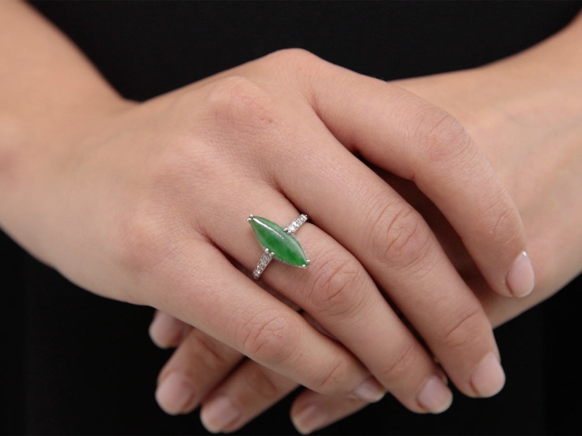 Navette green jade and diamond ring worn on hand