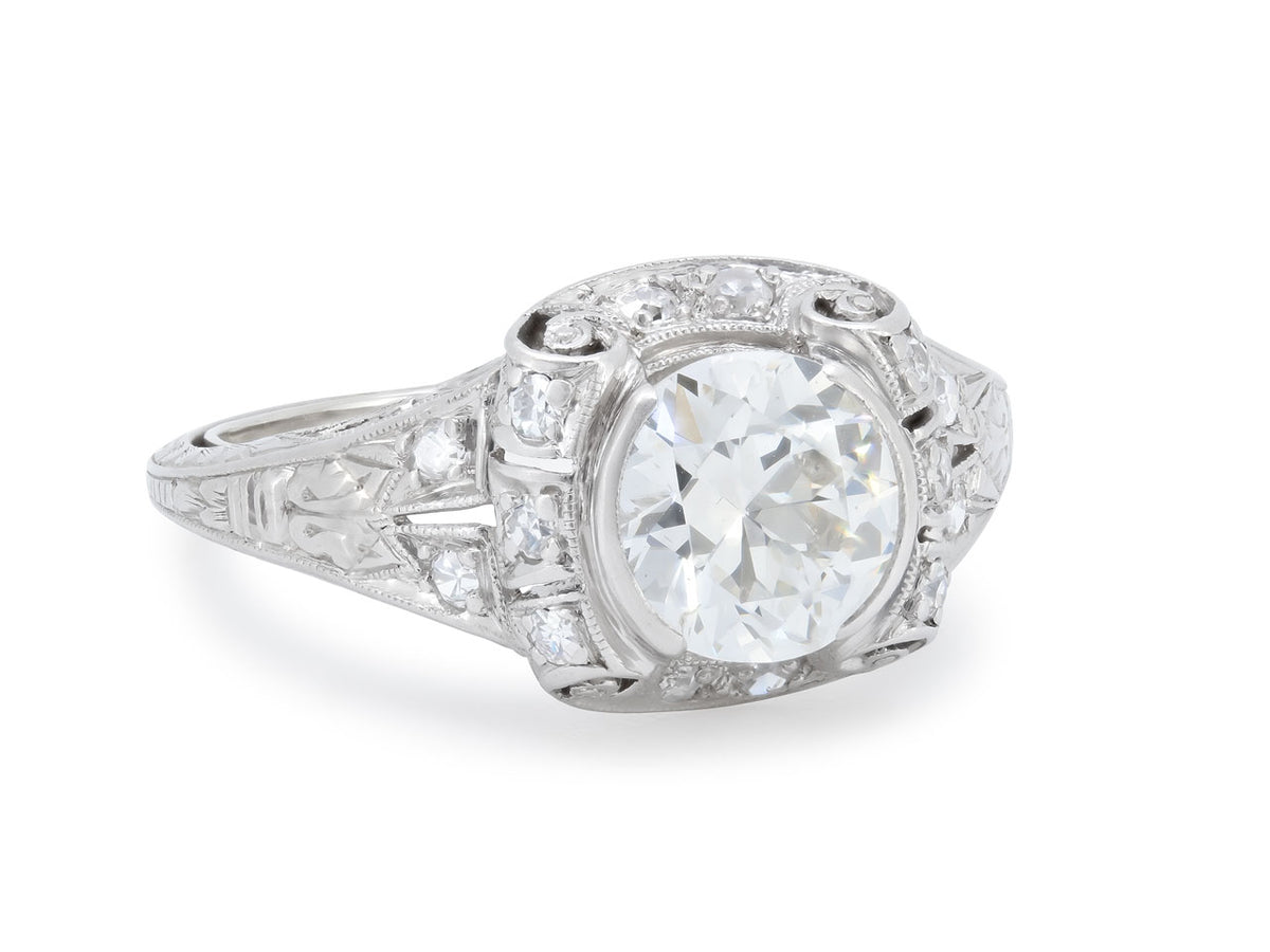 Platinum ring with transitional cut diamond and scrollwork