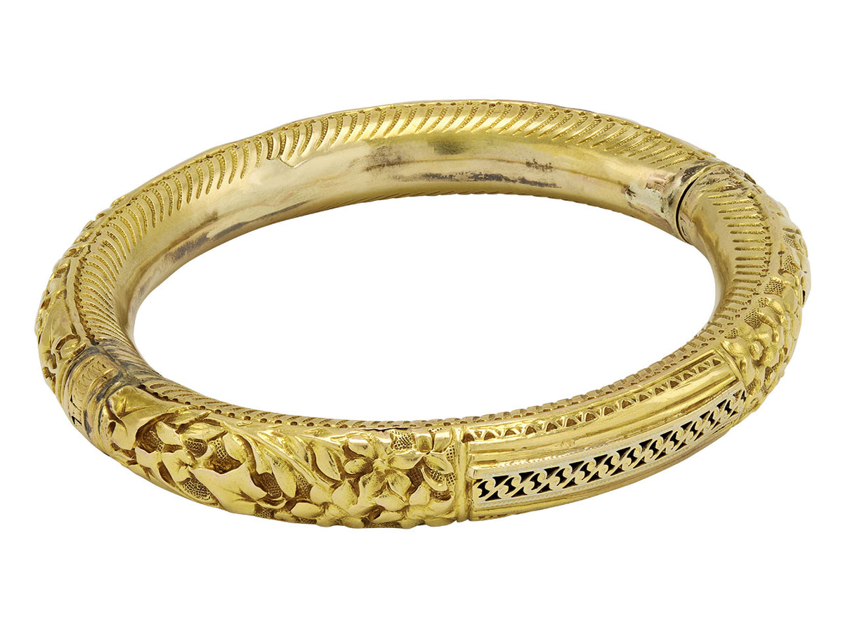 Antique 18K gold hinged bangle with foliate carvings