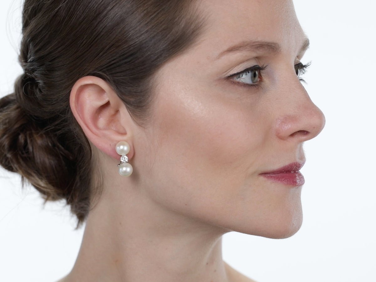 Woman wearing a two pearl diamond earring in profile