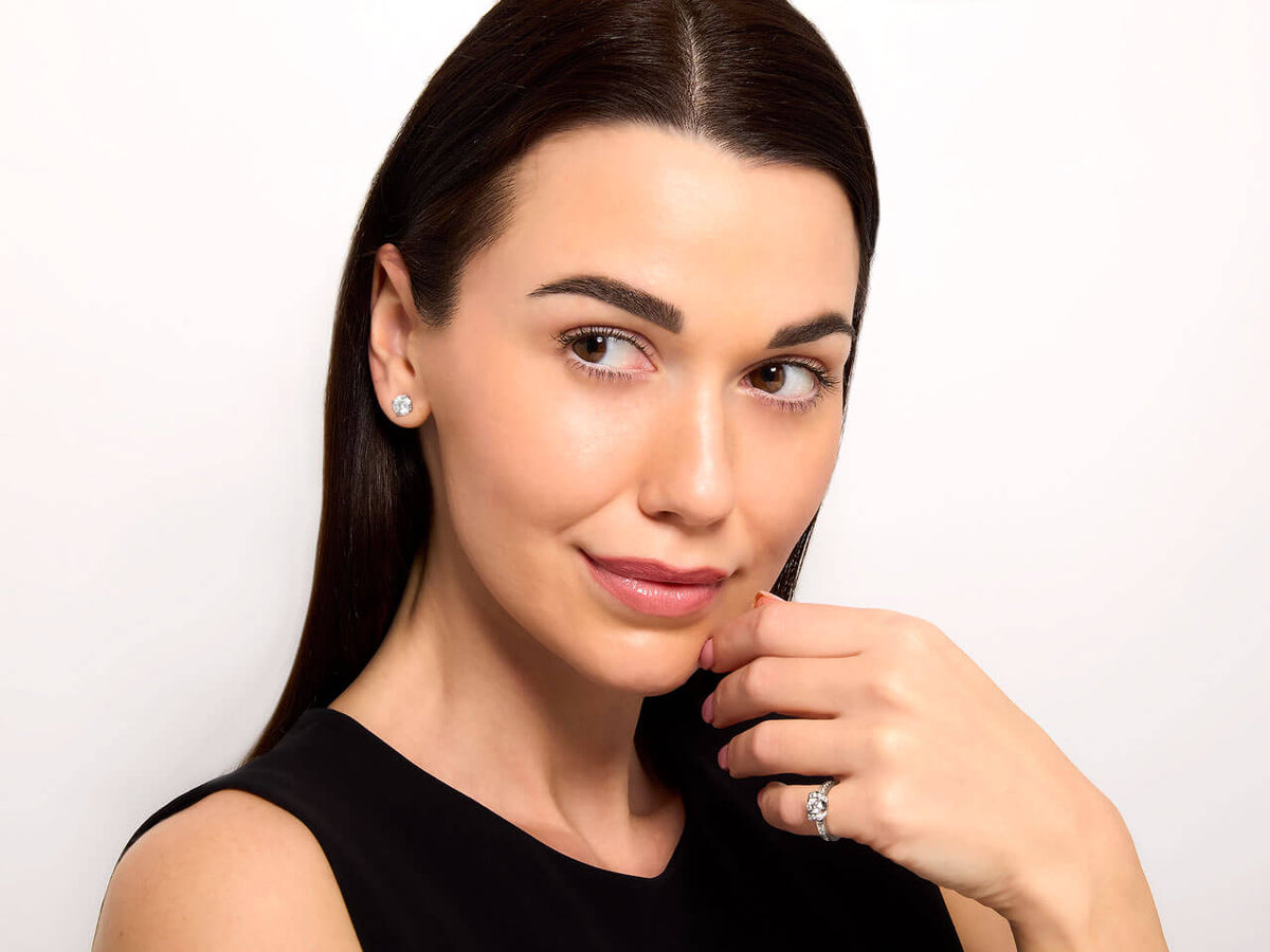 Woman wearing a diamond ribbon ring on her hand